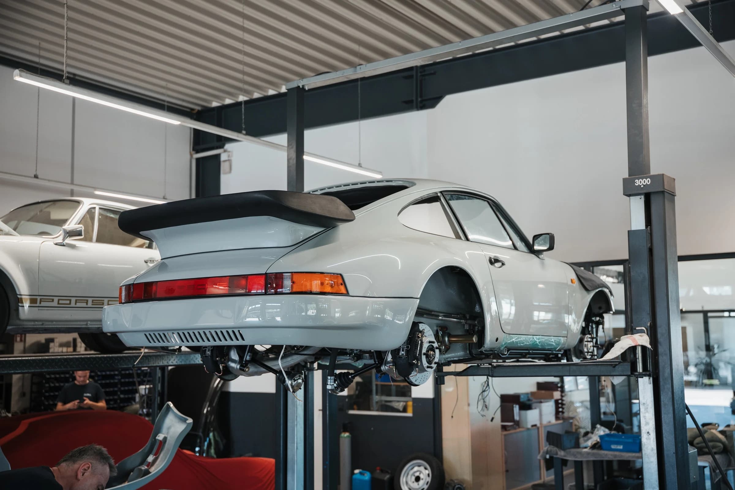 Banyan Porsche 930 Turbo in final assembly on a workshop lift