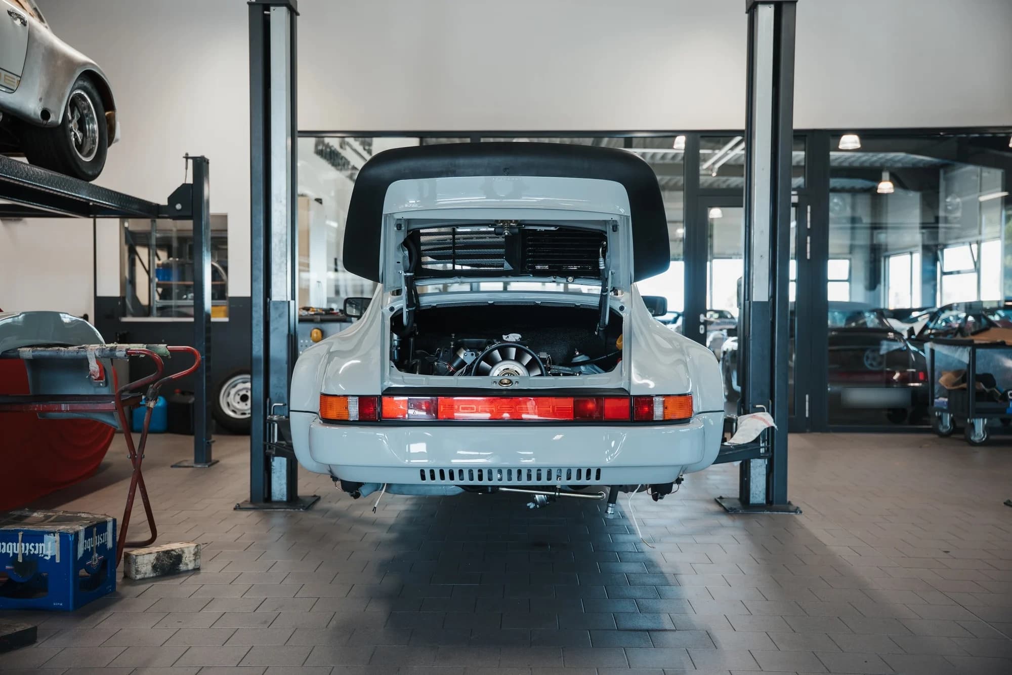 Rear view of the Porsche 930 with its engine bay open during final assembly