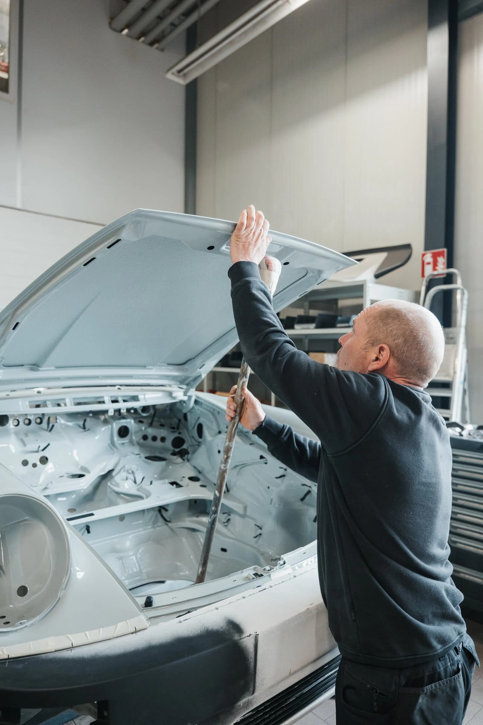Banyan technician fitting a panel to the Porsche 930 body