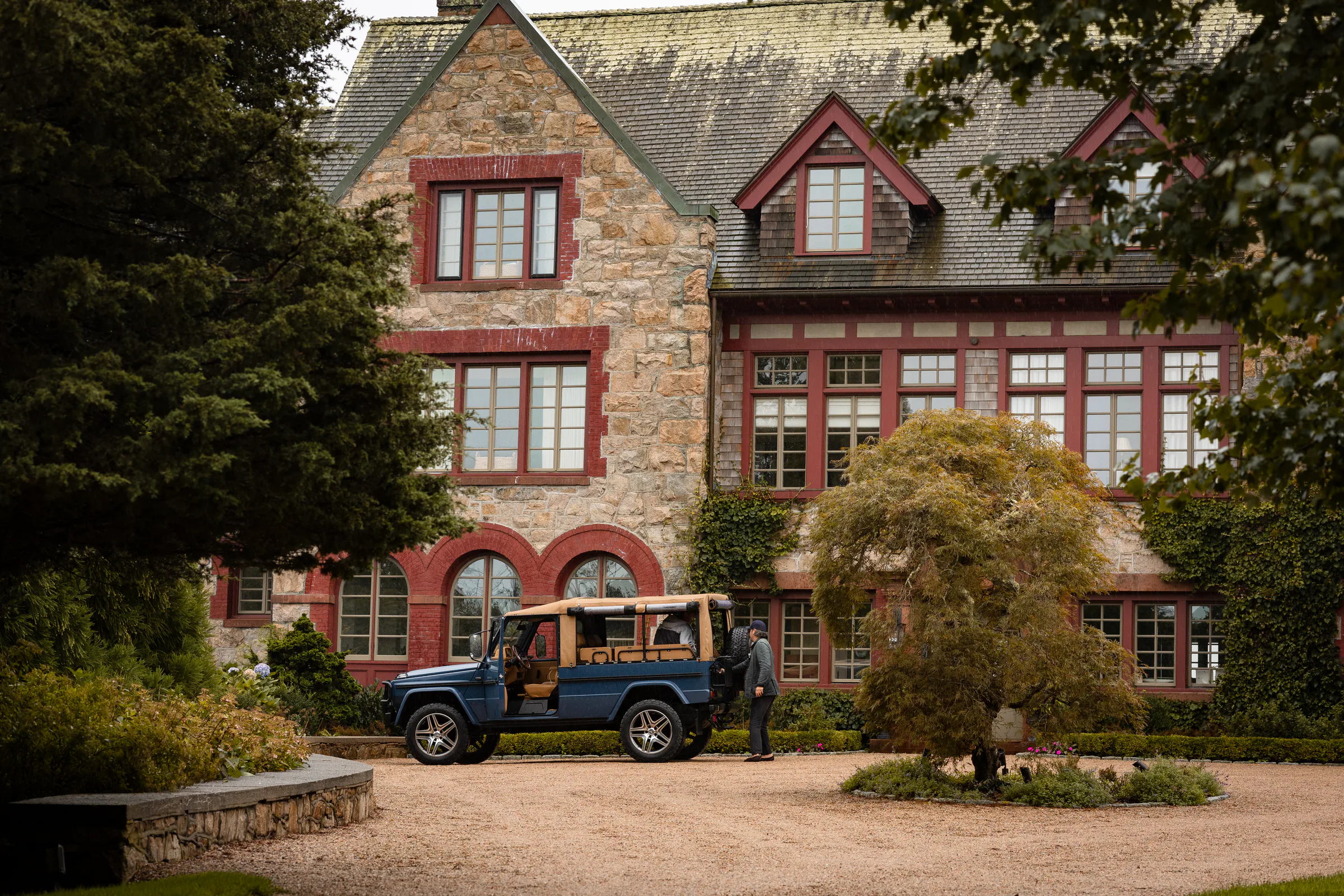 Banyan G-Class outside a historic stone home