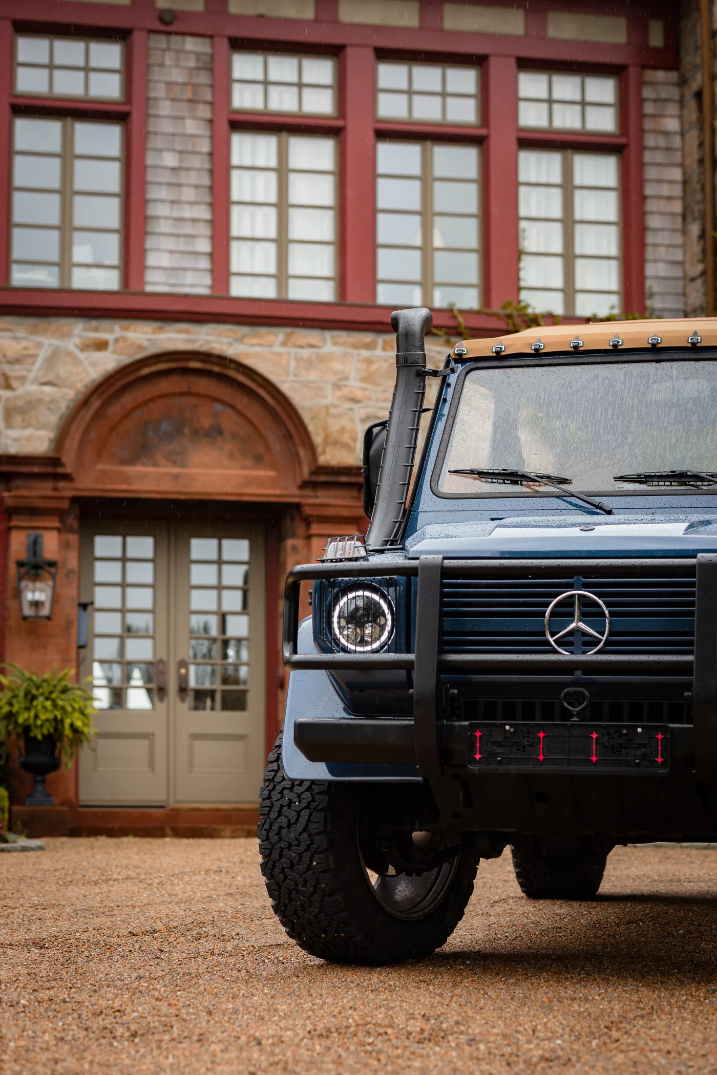 Banyan G-Class outside a historic stone home